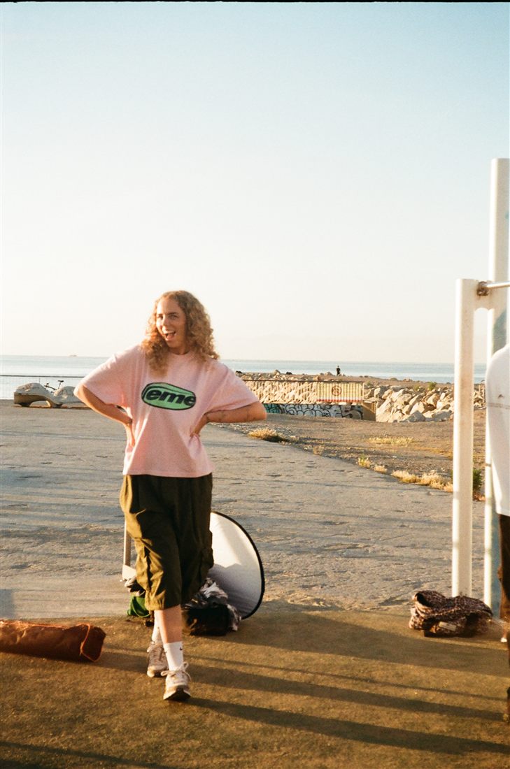Crew member laughing on a seafront location at golden hour