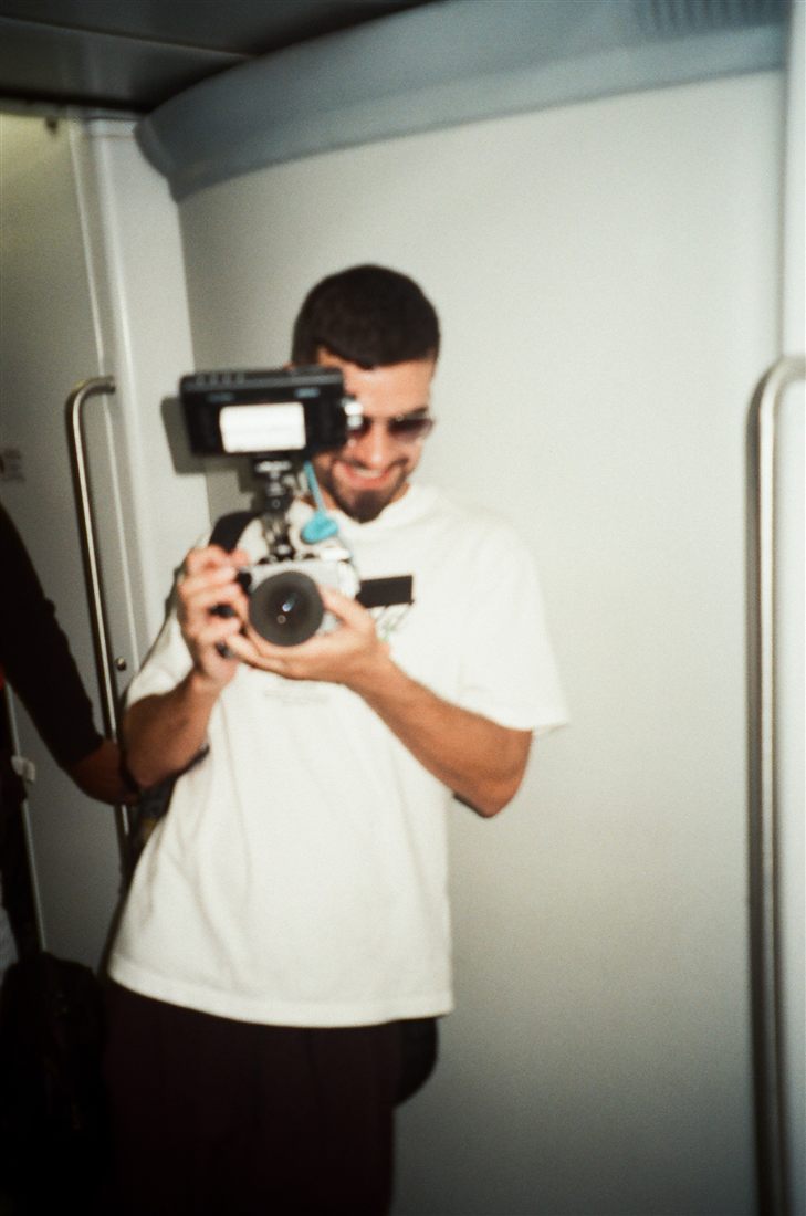 Filming with a small camera and a top-mounted monitor in a narrow white interior